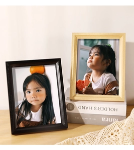Detail of wooden picture frames in brown and natural wood finish on a desk