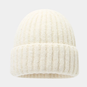 Detail of cream white ribbed knit beanie cap featuring warm thick textured material
