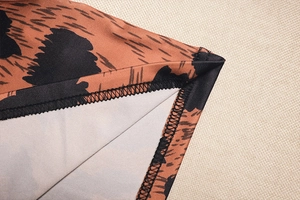 Macro shot of leopard print dress hem with high-quality stitching and elastic fabric