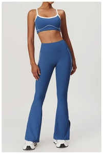 Detail of high-waisted flared yoga pants with white piping and inner slit design