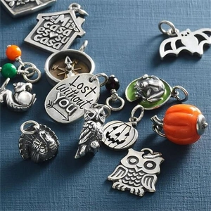 Detailed collection of assorted enamel and stainless steel festive charms on a blue background