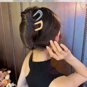 U-shaped hair pins in matte blue and beige shown on a bun for a secure hold