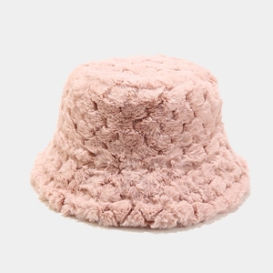 Close-up of pink faux fur texture on a warm winter bucket hat with plush material