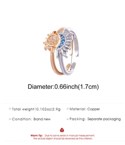 Macro detail of sun and moon rings showing copper material and crystal inlay dimensions