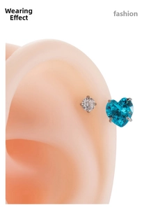 Macro shot of horseshoe ring set with sea blue heart zircon and clear round stud