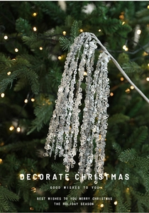 Close-up of sparkling silver sequin Christmas picks with festive bokeh background