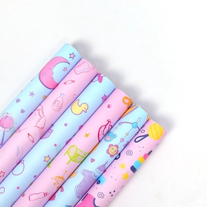 Cartoon baby gift wrapping paper rolls featuring cute blue and pink patterns