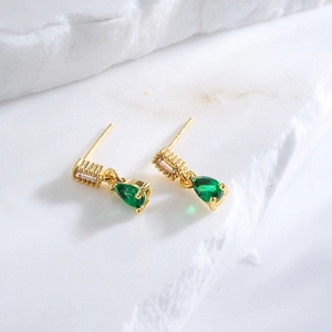 18K gold plated teardrop earrings with green zircon and rectangle crystals on marble
