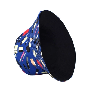 Detail of reversible sun hat with blue cosmetic print and solid black inner fabric