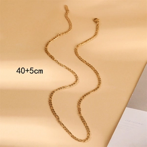 Detail of 18K gold Figaro chain necklace with 40+5cm length measurement on beige background