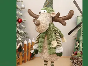 Detail of Christmas reindeer doll in green winter outfit with knit scarf and striped legs
