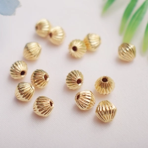 Macro shot of 14K gold-filled striped pumpkin spacer beads for DIY jewelry making