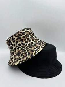 Detail of reversible leopard print bucket hat and classic black cotton sun hat set