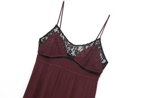 Close-up of wine red slip dress featuring black lace trim and delicate spaghetti straps