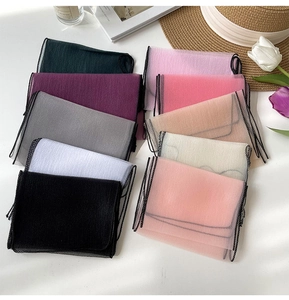 Detailed view of lightweight organza scarves in various colors with elegant lace trim edge