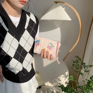Detail of pink jacquard makeup pouch with cherry embroidery and drawstring closure