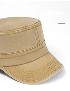 Detailed close-up of wide-brimmed khaki military cap with washed canvas texture