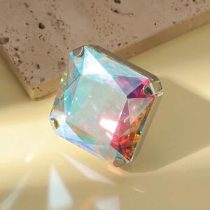 Macro view of square iridescent crystal ring with rainbow light reflection on surface