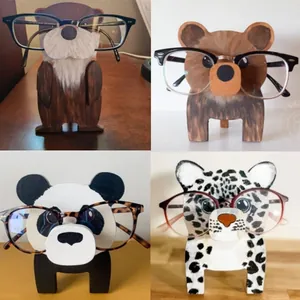 Detailed collage of four animal-shaped wooden eyeglass holders on a desk surface