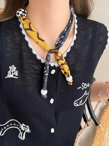 Detailed shot of ethnic floral heart pendant necklace with leopard print fabric scarf