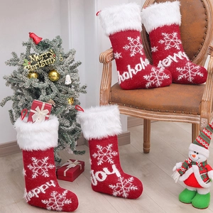 Knitted Christmas stockings with white snowflake patterns and plush faux fur cuffs