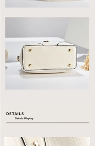 Detail of white bucket bag bottom featuring four golden protective studs on pebble leather