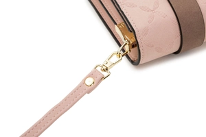 Detail of pink faux suede phone bag with geometric pattern and gold hardware