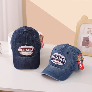 Detail of vintage denim baseball caps with Reliable embroidery in dark and light blue washes