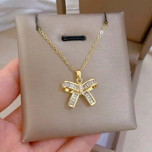 Detailed close-up of a luxury gold-plated titanium necklace with a zircon butterfly pendant