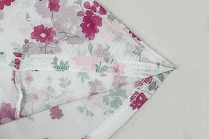 Macro detail of breathable mesh fabric with floral print and high-quality seam stitching