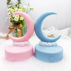 Close-up of pink and blue crescent moon night lights with cloud bases and heart switches