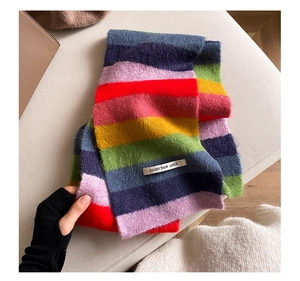 Detailed texture of rainbow striped mohair scarf with knitted fabric and woven brand label