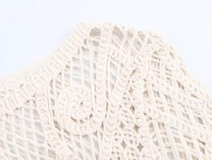 Detailed close-up of bohemian crochet long sleeve top featuring intricate macramé patterns