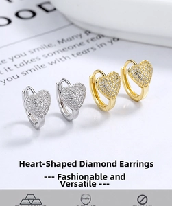 Detail of S925 sterling silver heart earrings with pave zircons in gold and silver