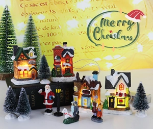 Macro detail of lighted resin Christmas village set with ice cream and toy shop miniatures