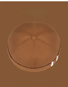 Top view of caramel docker hat featuring white side stripes and 6-panel stitch design