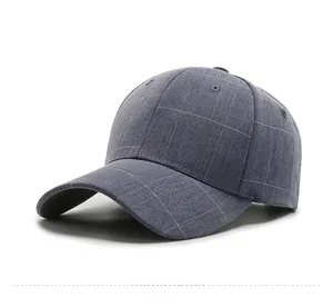 Detail of the gray baseball cap featuring fine plaid fabric and reinforced stitching