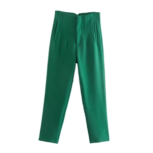Detail view of green high waist straight leg trousers showing fabric and minimalist design