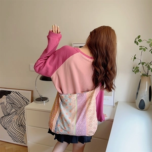 Floral patchwork canvas tote bag shown as part of a casual outfit over the shoulder