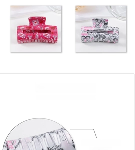 Detail view of smooth polished edges on acrylic hair claws with romantic patterns