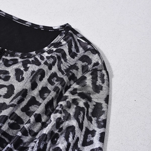 Detailed view of shimmering silver leopard print fabric with a v-neckline and shoulder seams