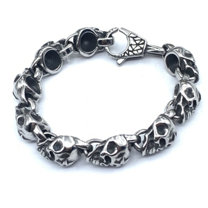 Detailed close-up of a silver punk skull bracelet link with a secure lobster clasp
