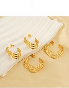 Detail of 18K gold-plated stainless steel geometric earrings on a display board