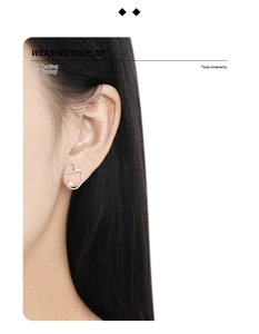 Wearing display of irregular silver heart stud earring with an embedded white pearl inlay