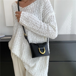 Minimalist black leather crossbody bag with vintage golden horseshoe buckle for women