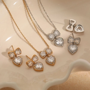 Bow heart pendant necklace and earrings set with zircon in gold and silver finish