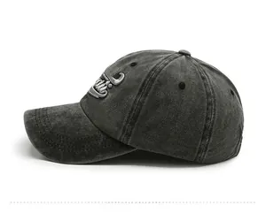 Detailed side view of washed dark grey cotton baseball cap with 3D embroidery detail