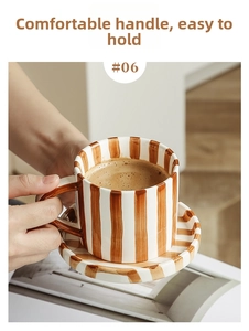 Detail of hand-painted ceramic coffee mug with brown vintage stripes and comfortable handle
