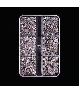Detailed view of 6-grid nail art crystal set with white flatback rhinestones in various sizes
