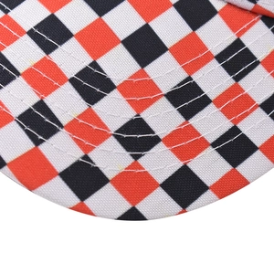 Close-up of checkered sun hat brim showing red and black pattern and precise stitching